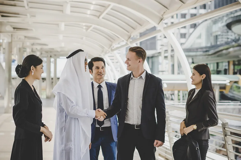 partners-greeting-one-another-by-handshaking-way-office